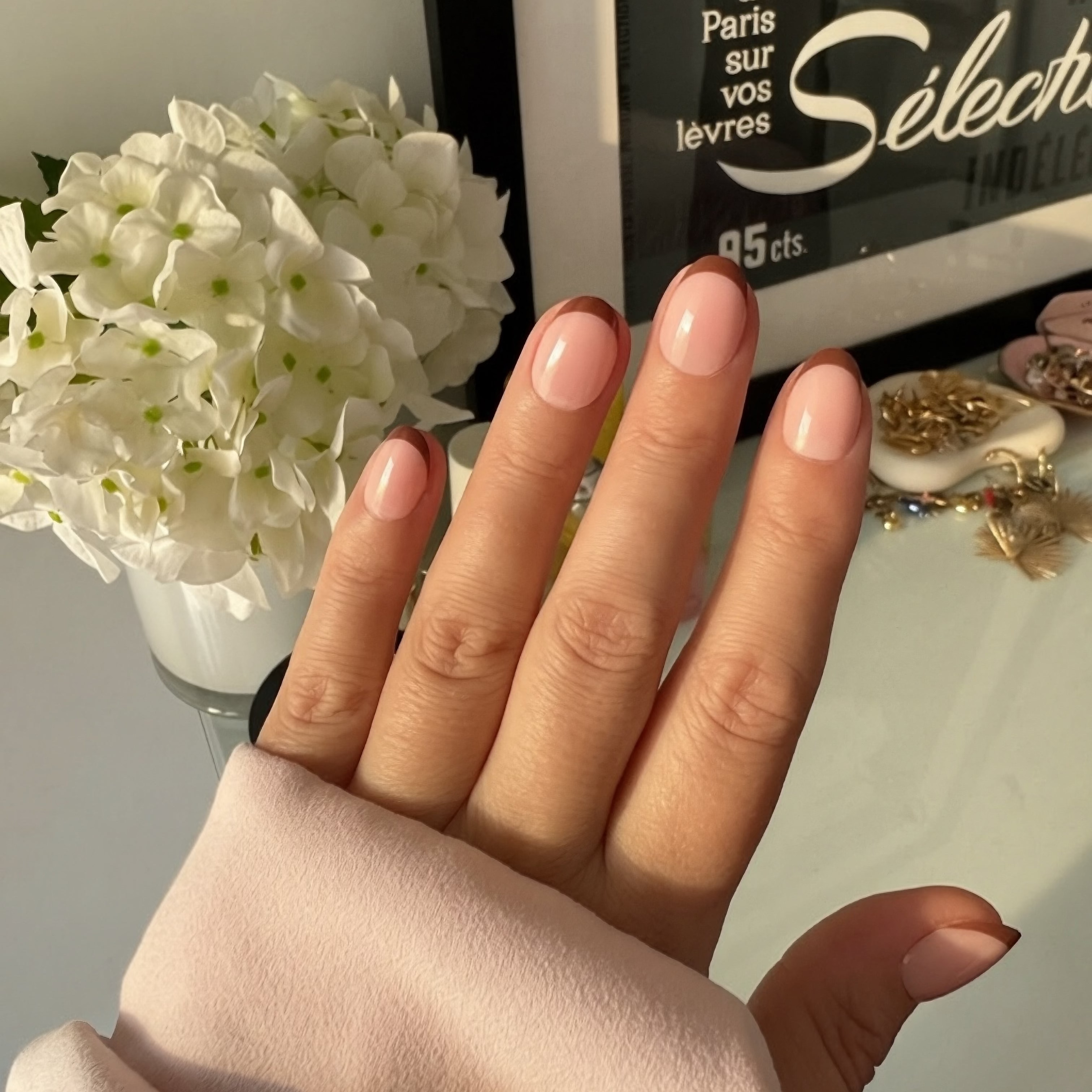 Instant Mani Co Choc Top brown micro french press on nails with flowers and jewellery in background