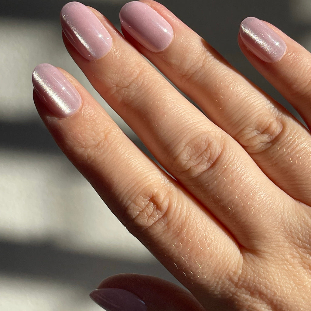 Girl wearing Instant Mani Co Bewitched velvet pink press on nails 