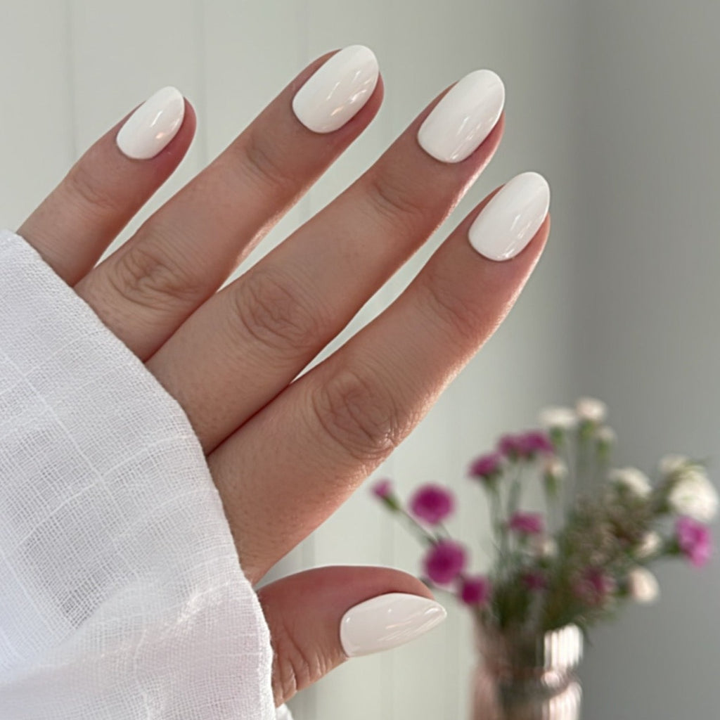 Girl wearing Instant Mani Co. Coconut Crush white short round press on nails