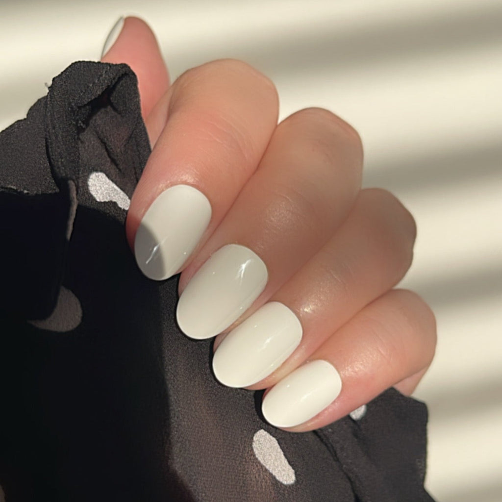 Girl wearing Instant Mani Co. Coconut Crush white short round press on nails