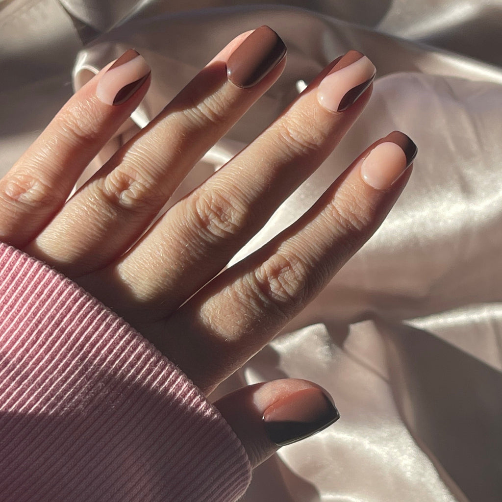 Girl wearing long sleeve pink top and also wearing Instant Mani Co. dark brown Drama press on nails