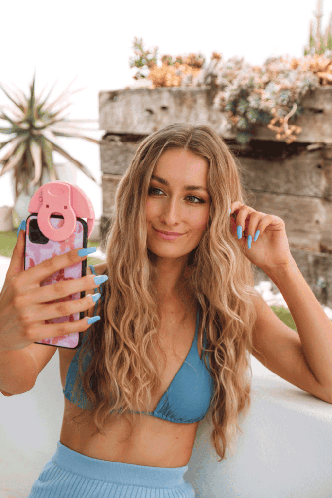 gif of girl taking a nail selfie, naifie, while wearing a set of Instant Mani press-on blue Hvar nails. 