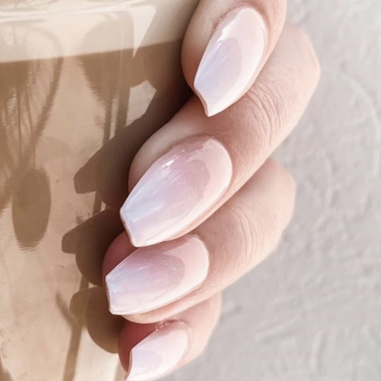 Girl holding latte, wearing ombre glue on nails