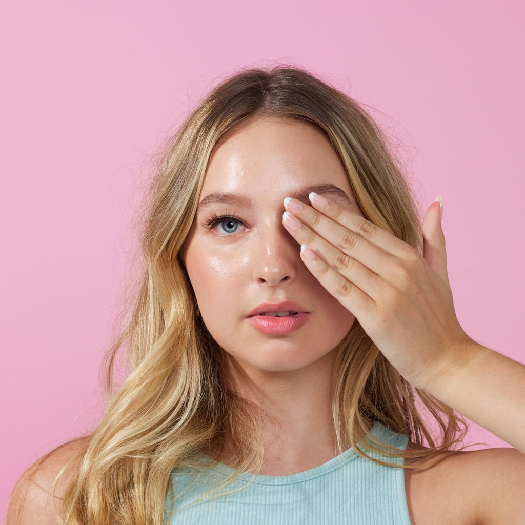 Girl  wearing  Instant Mani press on nails in front of pink background