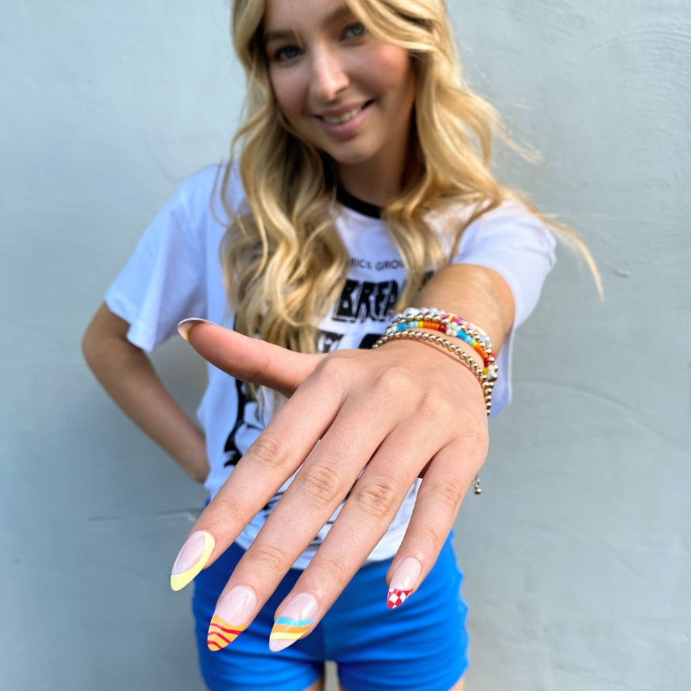 Girl wearing Carnival Instant Mani press on nails set
