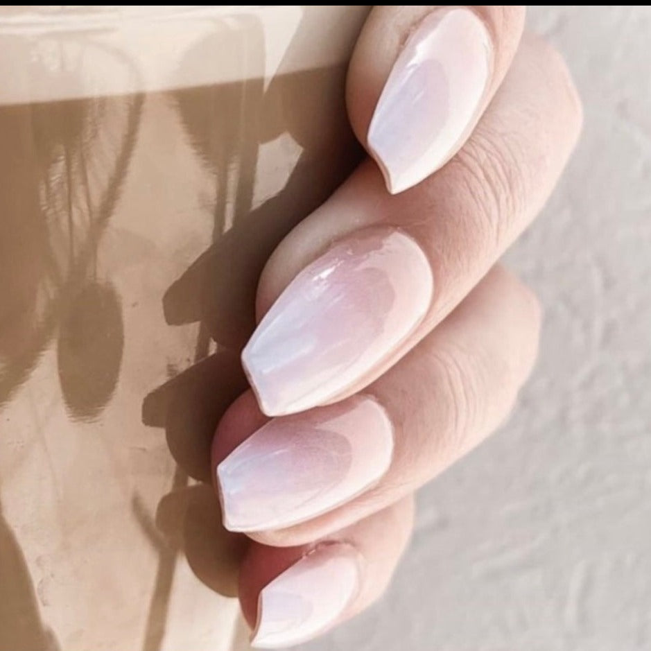 Coffee cup being held by girl wearing Instant Mani Co. Ombre press-on nails