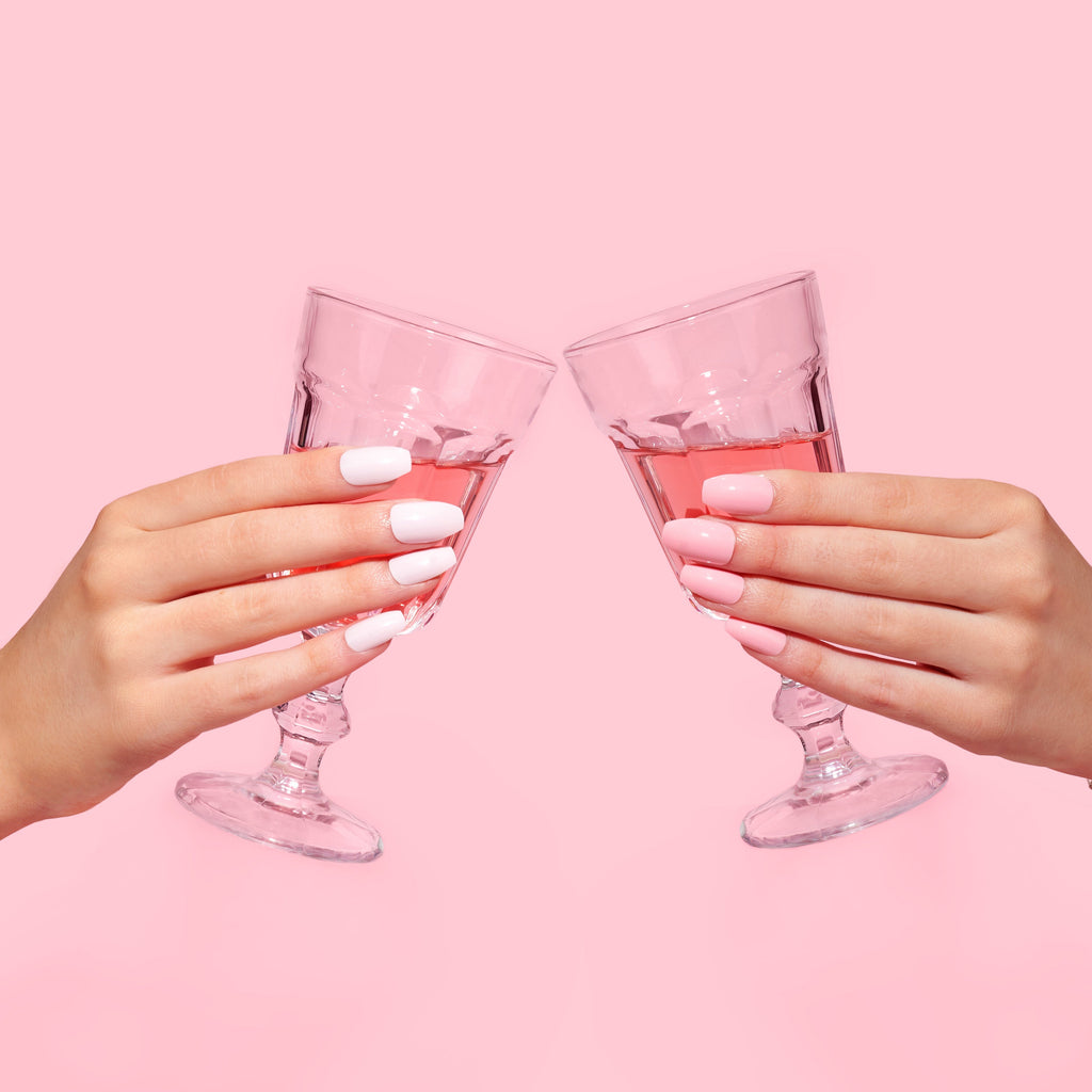 cheersing drinks, wearing pink press-on nail 