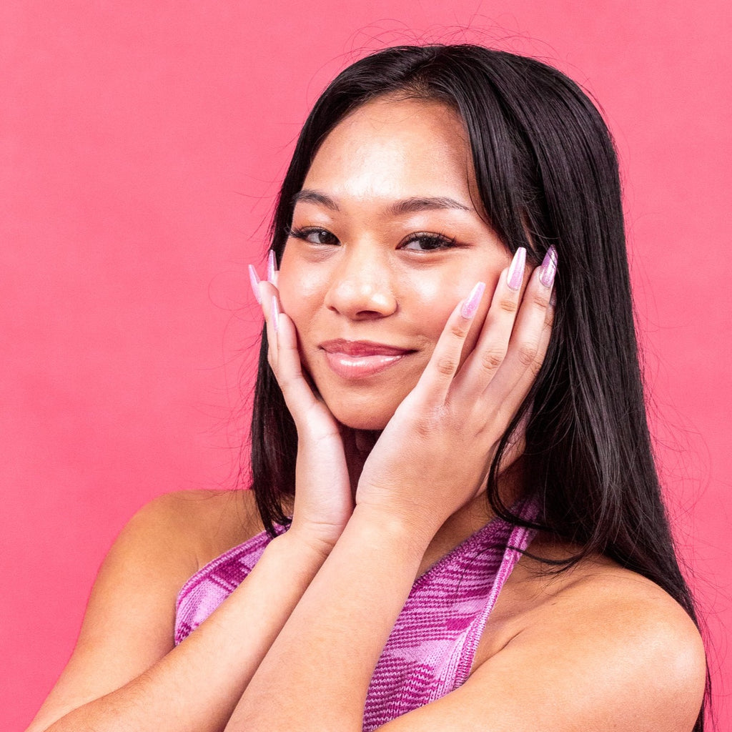 Girl wearing pink sparkly Instant Mani Co. press-on nails. 